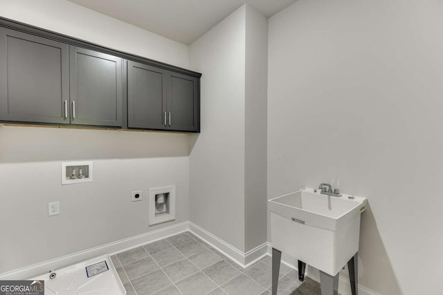 washroom featuring cabinets, light tile patterned floors, electric dryer hookup, and hookup for a washing machine