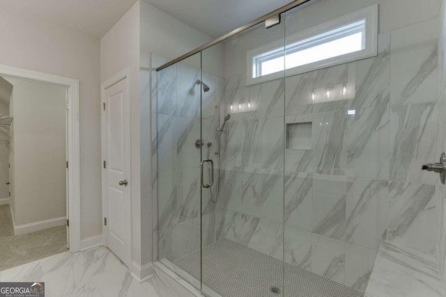 bathroom featuring a shower with shower door