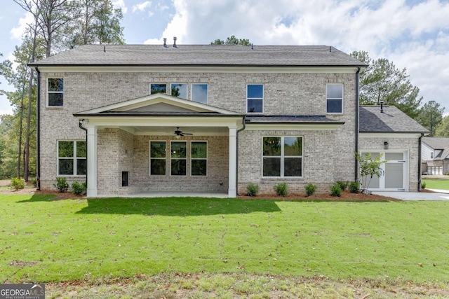 rear view of house featuring a garage, a lawn, ceiling fan, and a patio area