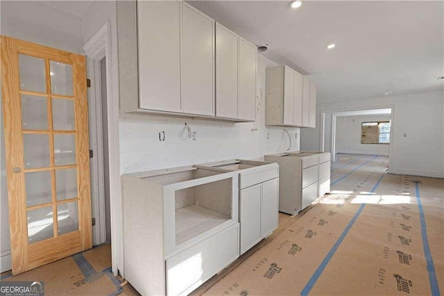 kitchen featuring white cabinetry and washer / dryer