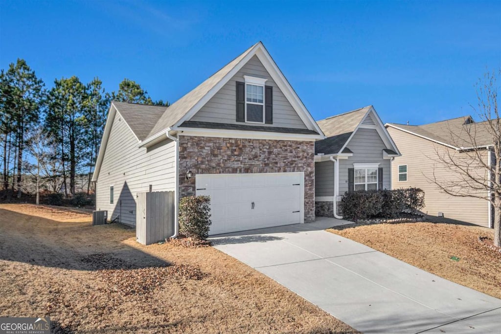 view of front of house with central AC and a garage