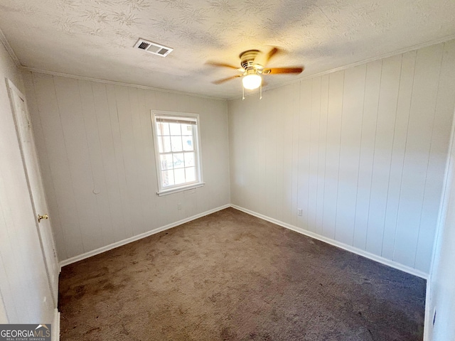 carpeted spare room featuring a textured ceiling and ceiling fan