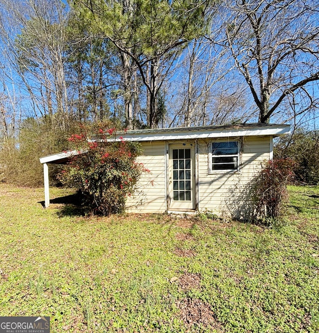 view of outbuilding with a yard