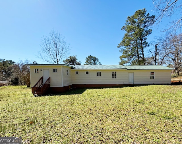 rear view of property featuring a yard