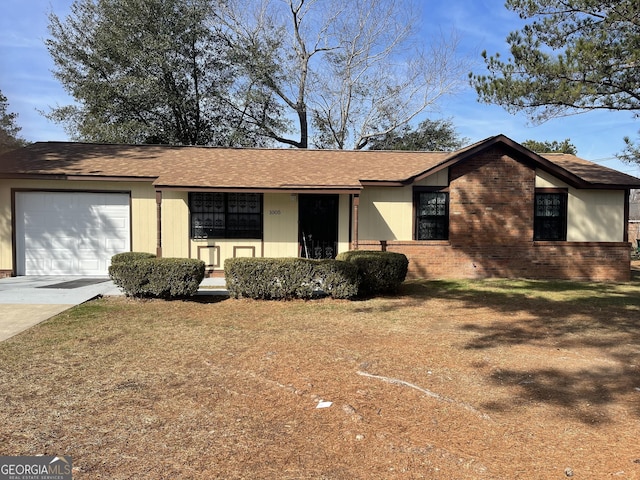 single story home with a front yard and a garage