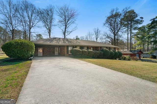 view of front of property with a front yard and a carport