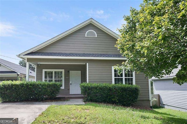 bungalow-style house with covered porch and a front yard