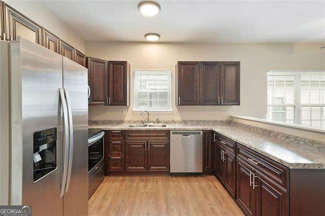 kitchen featuring sink, stainless steel appliances, and light hardwood / wood-style flooring