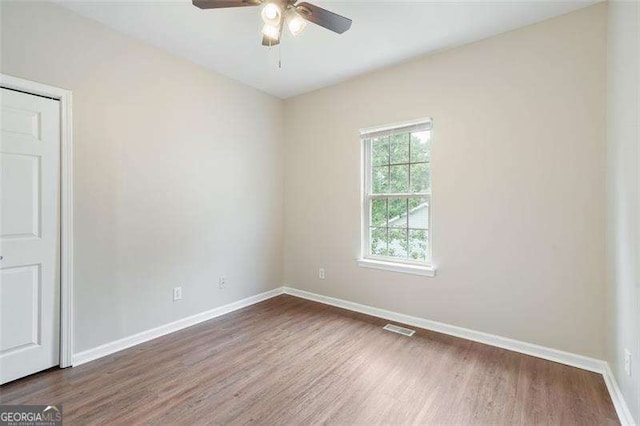 empty room featuring hardwood / wood-style flooring and ceiling fan