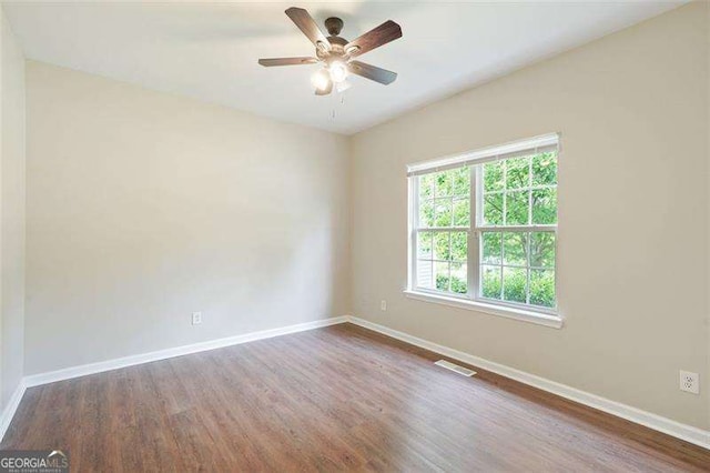 spare room with ceiling fan and wood-type flooring