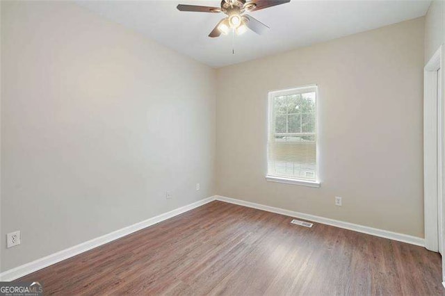 spare room with hardwood / wood-style flooring and ceiling fan