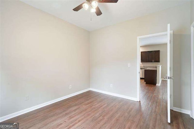 unfurnished room featuring hardwood / wood-style flooring and ceiling fan