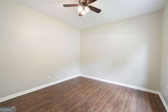 spare room featuring ceiling fan and dark hardwood / wood-style floors