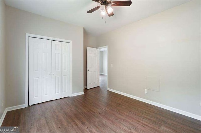 unfurnished bedroom with a closet, dark hardwood / wood-style floors, and ceiling fan