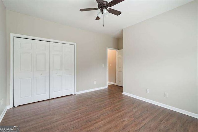 unfurnished bedroom with ceiling fan, a closet, and dark hardwood / wood-style flooring