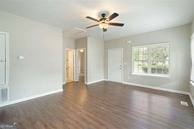 unfurnished living room with ceiling fan and dark wood-type flooring