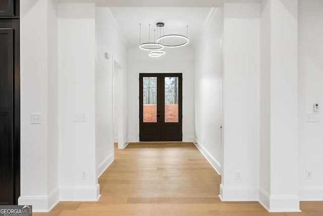 entryway with light hardwood / wood-style flooring and french doors