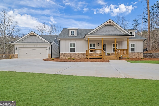 craftsman inspired home with a front yard, a garage, and a porch