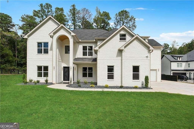 view of front of property featuring a garage and a front lawn