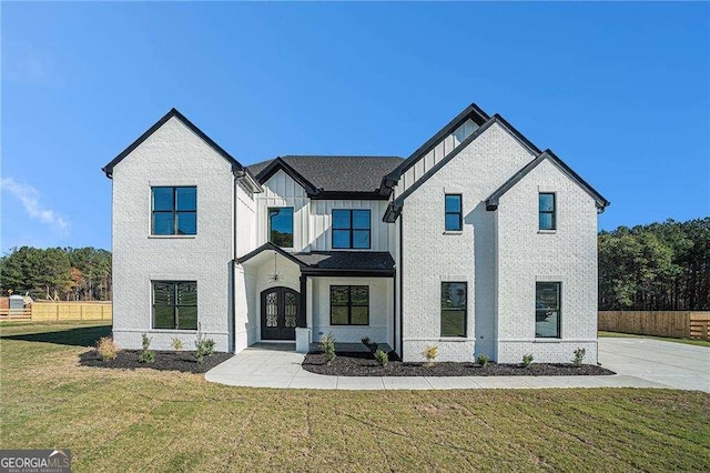 view of front of house with french doors and a front lawn