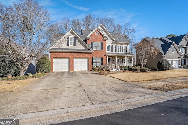 view of front of house featuring driveway, covered porch, a garage, and brick siding