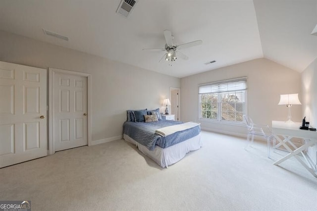 bedroom featuring ceiling fan, vaulted ceiling, and light colored carpet