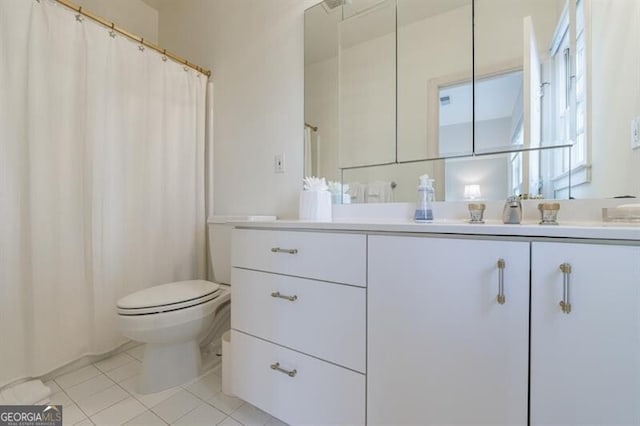 bathroom featuring tile patterned floors, vanity, and toilet