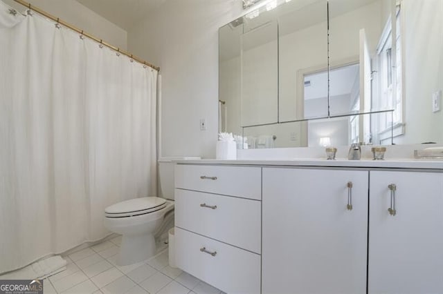 bathroom featuring tile patterned floors, toilet, and vanity