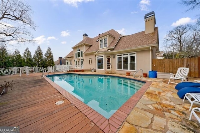 view of swimming pool featuring a deck