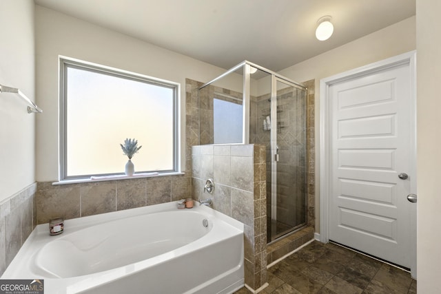 bathroom with separate shower and tub