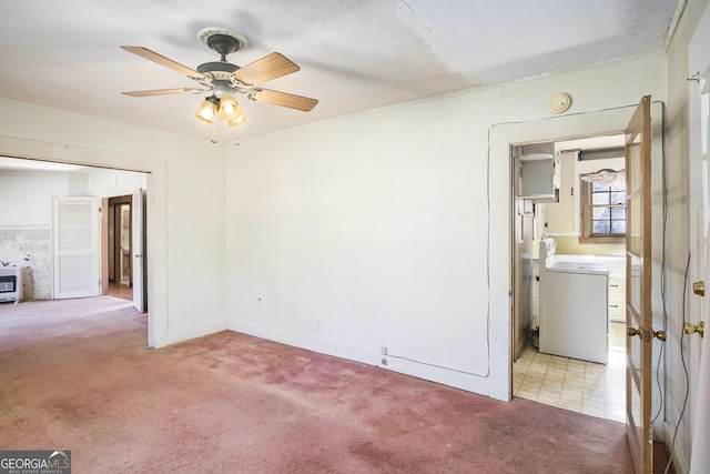 unfurnished room with ornamental molding, washer / clothes dryer, light carpet, and a ceiling fan