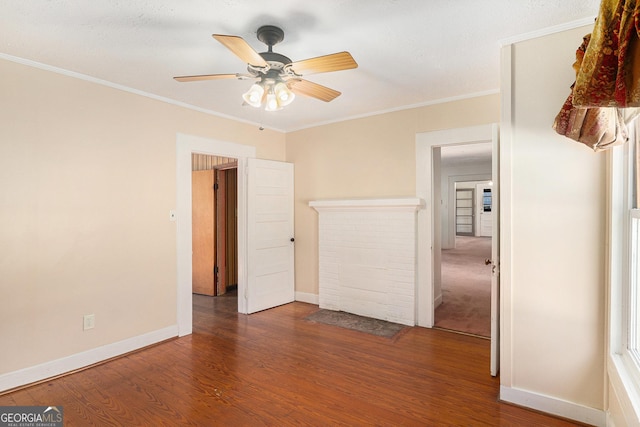 unfurnished bedroom featuring baseboards, ornamental molding, ceiling fan, and wood finished floors