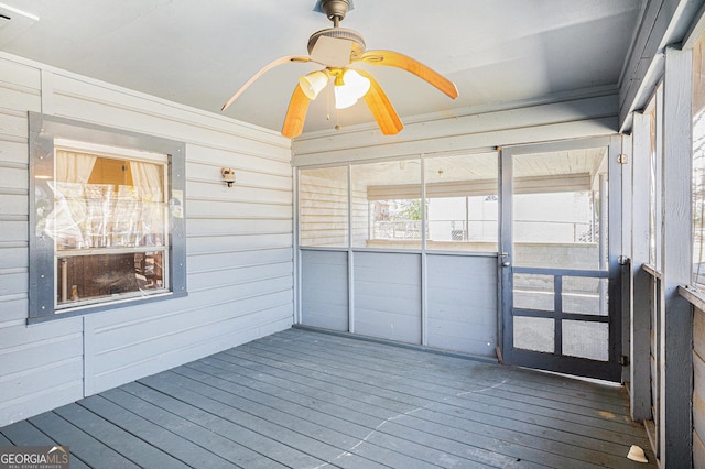 unfurnished sunroom with ceiling fan