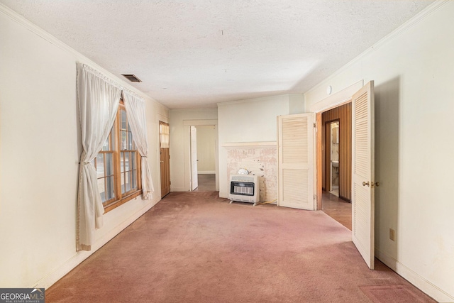 unfurnished living room with carpet floors, crown molding, a textured ceiling, and heating unit