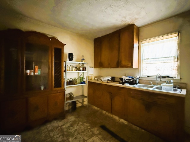 kitchen featuring sink and a textured ceiling