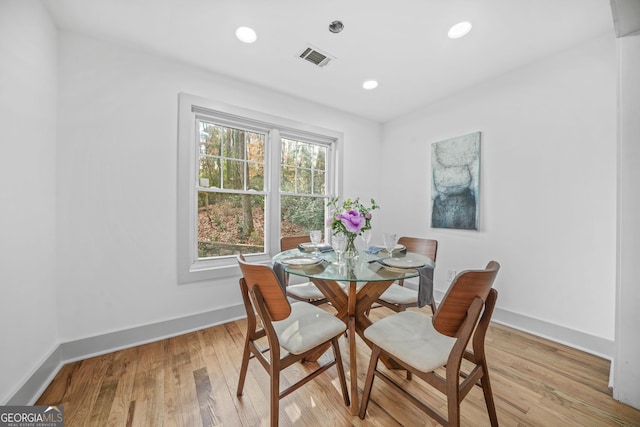 dining space with light hardwood / wood-style flooring