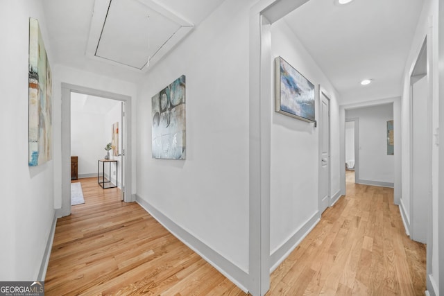 hallway with light hardwood / wood-style floors