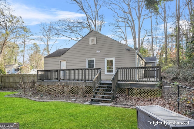 rear view of property featuring a yard and a deck