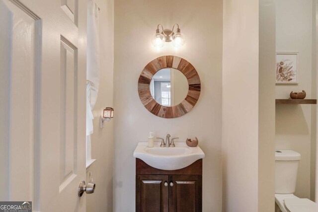 bathroom featuring toilet and vanity