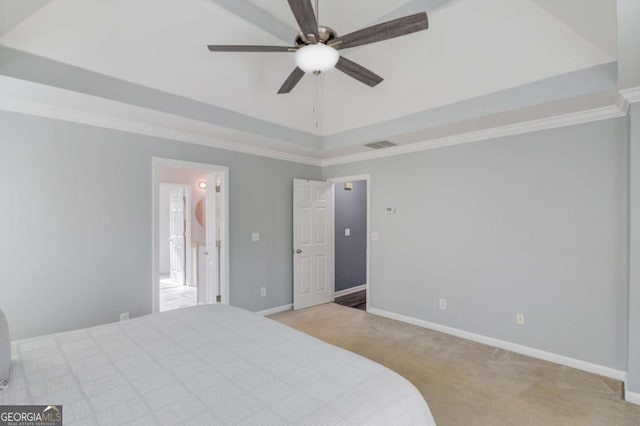 carpeted bedroom with a raised ceiling, crown molding, visible vents, and baseboards