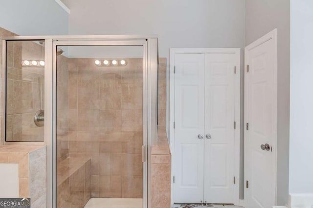 full bath featuring a stall shower and a closet