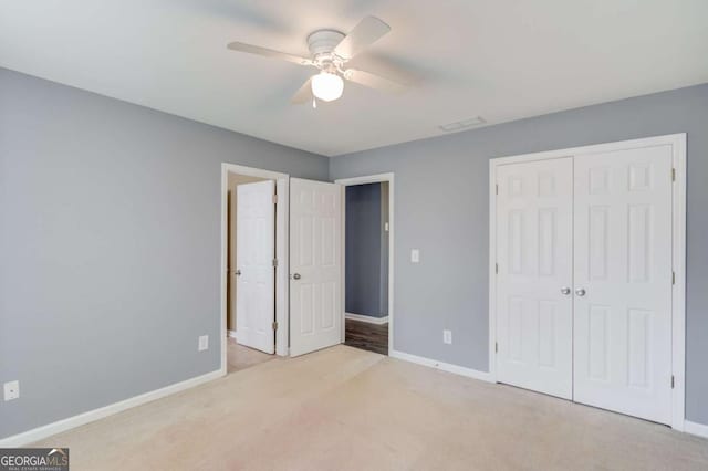 unfurnished bedroom featuring a closet, baseboards, and carpet floors