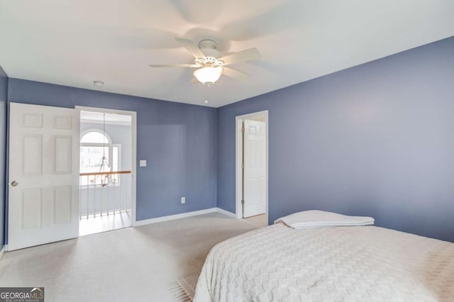 carpeted bedroom with baseboards and a ceiling fan