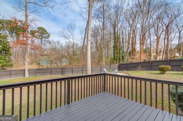 deck featuring a yard and a fenced backyard