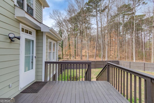 wooden terrace with a lawn, a fenced backyard, and outdoor dining space