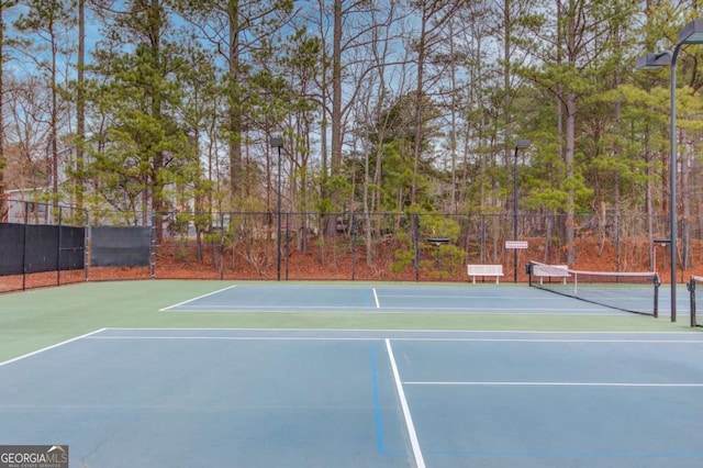 view of tennis court with fence