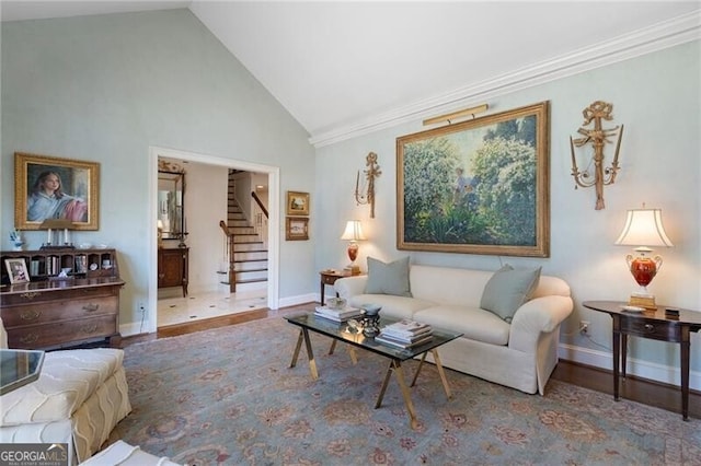 living room with ornamental molding, hardwood / wood-style flooring, and high vaulted ceiling