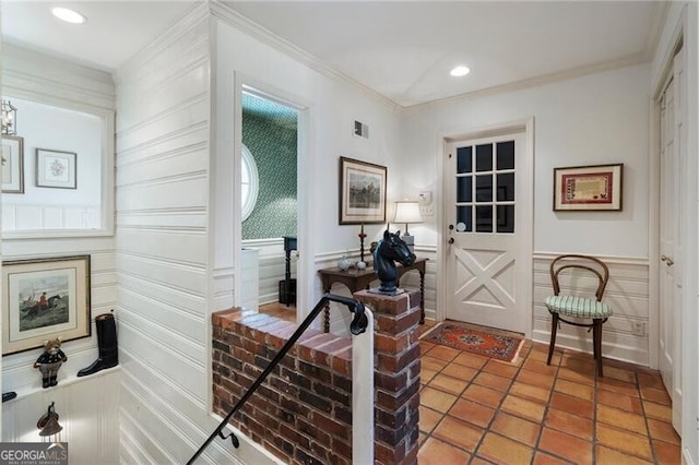 interior space featuring tile patterned flooring and crown molding