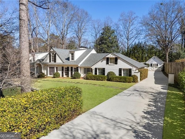 new england style home with a front lawn