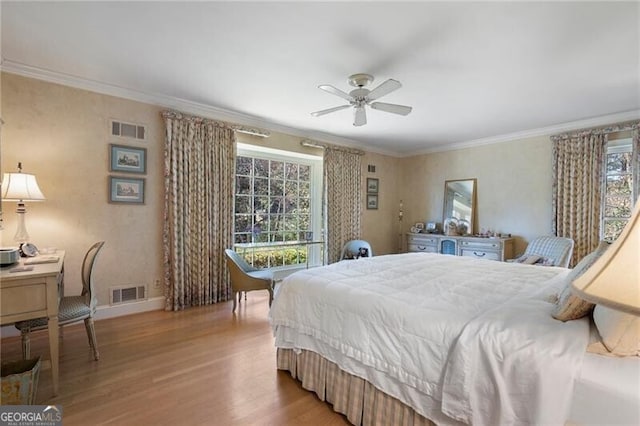 bedroom featuring ceiling fan, light wood-type flooring, and crown molding